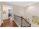 Upstairs hallway with hardwood floors and artwork at 3364 Northampton Dr, Charlotte, NC 28210