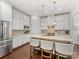 Modern kitchen with white cabinets, granite counters and island at 3364 Northampton Dr, Charlotte, NC 28210