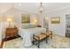 Main bedroom with king bed, ensuite bath access, and wood floors at 3364 Northampton Dr, Charlotte, NC 28210