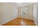 Simple bedroom with hardwood floors and neutral walls at 4017 Sulkirk Rd, Charlotte, NC 28210