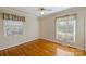 Bright bedroom with hardwood floors and two windows at 4017 Sulkirk Rd, Charlotte, NC 28210