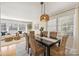 Bright dining room with wicker chairs and a dark table at 4017 Sulkirk Rd, Charlotte, NC 28210