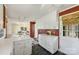 White kitchen cabinets and view into adjoining living area at 4017 Sulkirk Rd, Charlotte, NC 28210