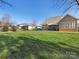 Large backyard with green grass and a partially visible home at 500 Planters Way, Mount Holly, NC 28120