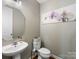 Clean bathroom with a pedestal sink and orchid artwork at 500 Planters Way, Mount Holly, NC 28120