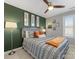 Bright bedroom with a green accent wall and comfortable bedding at 500 Planters Way, Mount Holly, NC 28120