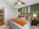 Bedroom with green accent wall, comfortable bedding, and ceiling fan at 500 Planters Way, Mount Holly, NC 28120