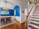 Bright dining room with hardwood floors and blue accent wall at 500 Planters Way, Mount Holly, NC 28120