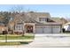 Two-story house with a three-car garage and manicured lawn at 500 Planters Way, Mount Holly, NC 28120