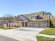 Two-story house with a three-car garage and landscaped yard at 500 Planters Way, Mount Holly, NC 28120