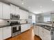 Spacious kitchen with an island, white cabinets and granite countertops at 500 Planters Way, Mount Holly, NC 28120