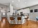 Modern kitchen with white cabinets and a breakfast bar at 500 Planters Way, Mount Holly, NC 28120