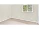 Bedroom featuring neutral carpet, walls, and a window bringing in natural light at 9106 Nash Ave, Charlotte, NC 28213