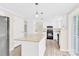 Open kitchen features white cabinets, granite countertops, stainless appliances and island with deck access at 9106 Nash Ave, Charlotte, NC 28213