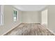 Living room featuring hardwood flooring and natural lighting with open access to the doorway at 9106 Nash Ave, Charlotte, NC 28213