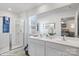 Bright bathroom with double sinks, large mirror, and a glass-enclosed shower with blue accents at 1144 Foxberry Ln, Maiden, NC 28650