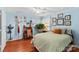 Cozy bedroom with light blue walls, hardwood floors, and a comfortable bed at 129 Ann St, Salisbury, NC 28146