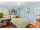 Light blue bedroom with hardwood floors, double bed, and built-in closet at 129 Ann St, Salisbury, NC 28146