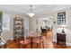 Bright dining room with hardwood floors, glass-top table, and view to living room at 129 Ann St, Salisbury, NC 28146