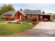Brick ranch house with carport and landscaped yard at 129 Ann St, Salisbury, NC 28146