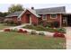Brick ranch home with landscaped gardens and walkway at 129 Ann St, Salisbury, NC 28146