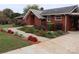 Brick ranch home with landscaped gardens and walkway at 129 Ann St, Salisbury, NC 28146