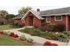 Brick ranch home with landscaped gardens and walkway at 129 Ann St, Salisbury, NC 28146