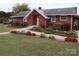 Brick ranch home with landscaped gardens and walkway at 129 Ann St, Salisbury, NC 28146