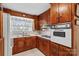 Classic kitchen with wood cabinets, built-in oven, and double sink at 129 Ann St, Salisbury, NC 28146