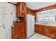 Galley kitchen with wood cabinets, refrigerator, and microwave at 129 Ann St, Salisbury, NC 28146