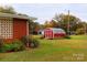 Red barn with partial view of brick house at 129 Ann St, Salisbury, NC 28146