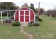Red barn-style shed with stone pathway at 129 Ann St, Salisbury, NC 28146