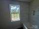 New bathroom with modern tile walls, a tub, and a window offering natural light and peaceful outdoor view at 184 Maplewood Ln, Taylorsville, NC 28681