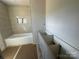 Tiled bathroom with a new tub and vanity area awaiting finishing touches at 184 Maplewood Ln, Taylorsville, NC 28681