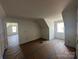 Spacious bedroom with natural light, sloped ceilings, and freshly painted walls at 184 Maplewood Ln, Taylorsville, NC 28681