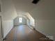 Spacious bedroom featuring sloped ceilings, newly painted walls, and a window at 184 Maplewood Ln, Taylorsville, NC 28681