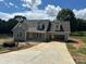 Charming new construction home featuring a gray exterior, dormer windows, and an attached two car carport at 184 Maplewood Ln, Taylorsville, NC 28681