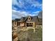 Front view of the new home, framing and roofing, with beautiful sky and clouds at 184 Maplewood Ln, Taylorsville, NC 28681