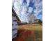 View from the side of a home construction site, showing the partially framed structure at 184 Maplewood Ln, Taylorsville, NC 28681