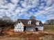 Exterior of the new construction home against a blue sky with scattered clouds at 184 Maplewood Ln, Taylorsville, NC 28681
