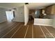 An unfinished living room with bare walls, a large window, and a view into the adjacent kitchen area at 184 Maplewood Ln, Taylorsville, NC 28681