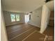 Spacious unfinished living room featuring a staircase, bare walls, and a front-facing window for natural light at 184 Maplewood Ln, Taylorsville, NC 28681
