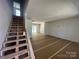 Unfinished living room with a staircase leading to the second floor and sliding glass doors to the outdoor patio at 184 Maplewood Ln, Taylorsville, NC 28681