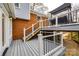 A two-story back deck featuring gray wood and white railings at 3319 Mill Pond Rd, Charlotte, NC 28226