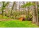 A back yard with a small wooden bridge in the distance at 3319 Mill Pond Rd, Charlotte, NC 28226