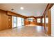 Basement with tile floors, wood paneling, wet bar, and sliding glass door, providing a flexible entertainment area at 3319 Mill Pond Rd, Charlotte, NC 28226
