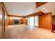 Finished basement features a fireplace, wood paneling, and sliding glass doors, perfect for cozy gatherings at 3319 Mill Pond Rd, Charlotte, NC 28226