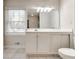 Classic bathroom with white vanity, ample lighting, and a window for natural light, creating a clean aesthetic at 3319 Mill Pond Rd, Charlotte, NC 28226