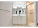 Elegant bathroom featuring tiled floors, a vanity with mirrored cabinets, and a glass door shower, offering functionality at 3319 Mill Pond Rd, Charlotte, NC 28226