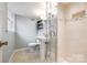 Bathroom featuring a glass shower, tile flooring, and a pedestal sink at 3319 Mill Pond Rd, Charlotte, NC 28226